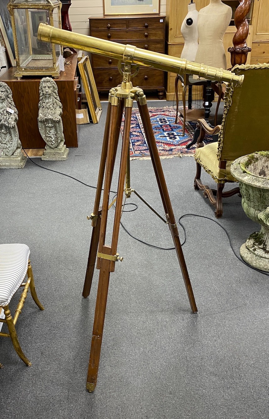 A Victorian style brass telescope on folding tripod, telescope length 71cm
